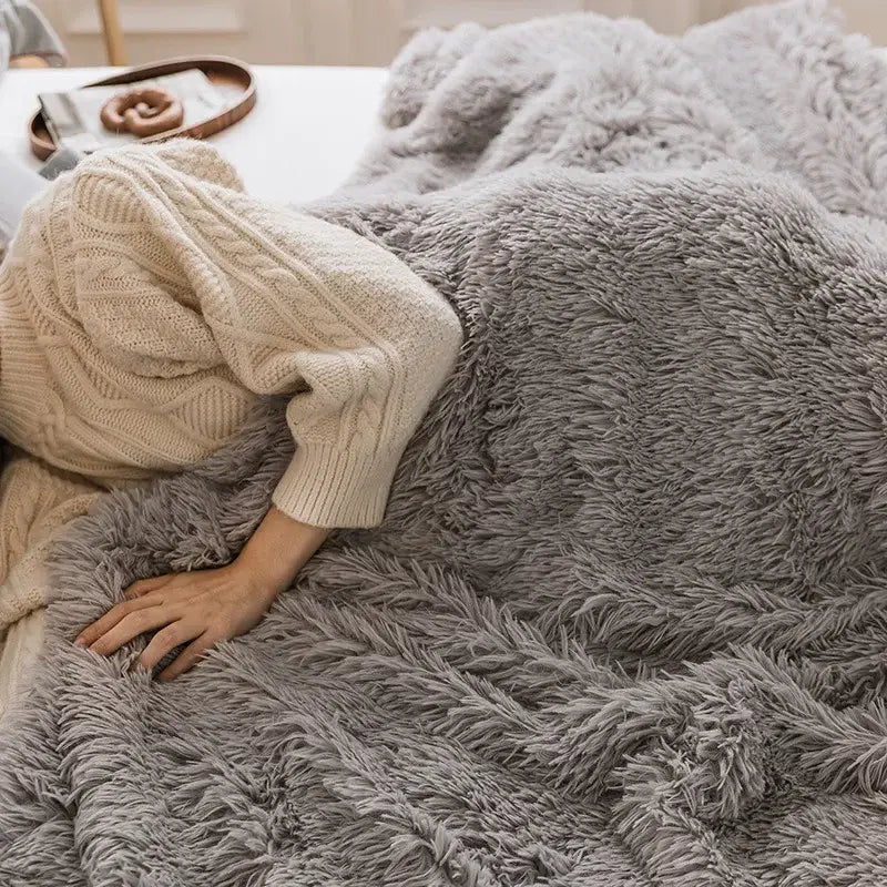 A cozy faux fur throw blanket in gray with soft shaggy texture perfect for decorbites cozy faux decor in pink bedroom