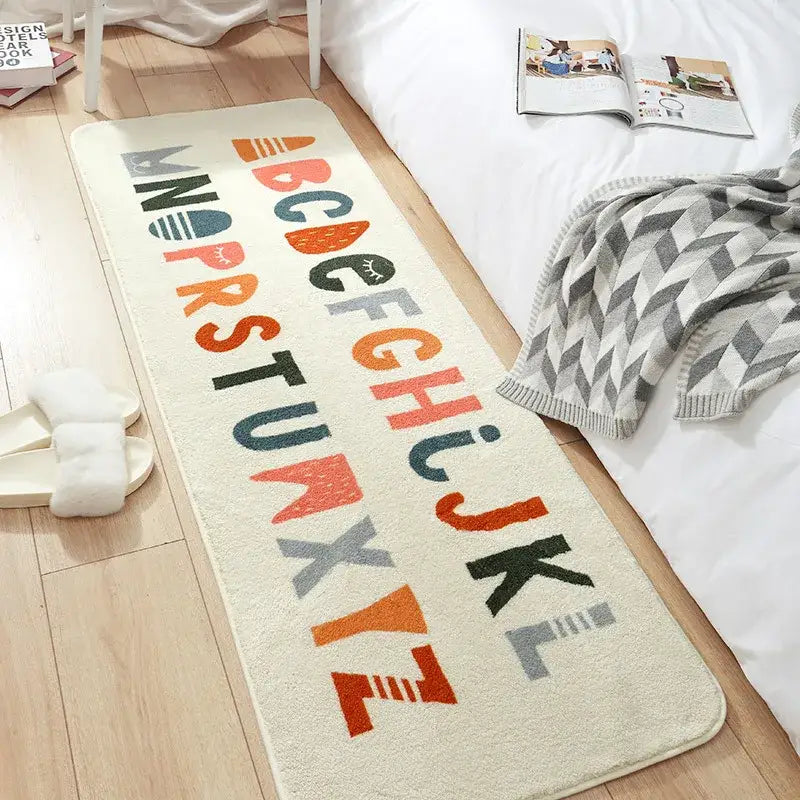 Cream-colored decorbites cozy faux lamb bedside rug with colorful playful alphabet letters for bedroom use