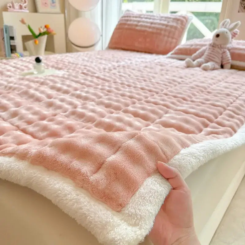 Pink quilted fleece mattress pad with plush white faux rabbit fur border for cozy faux rabbit decorbites bedroom mat