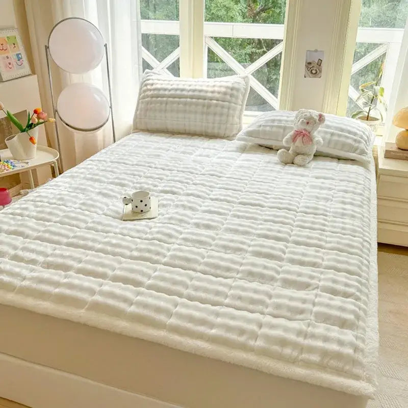 White quilted mattress pad with cozy faux rabbit fur texture and subtle grid stitching for decorbites cozy faux collection