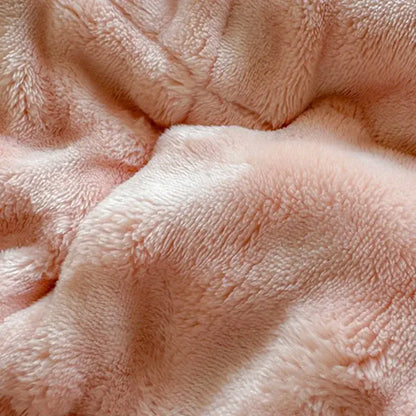 A soft blush-pink plush decorbites cozy faux rabbit fur quilted mattress pad with a cozy textured surface