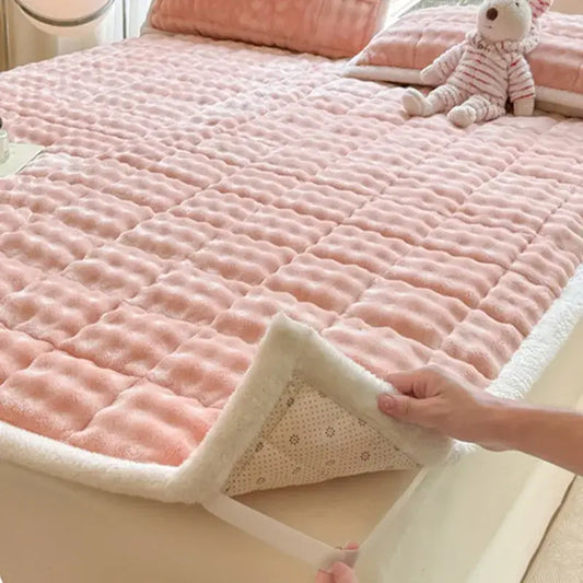 Pink quilted mattress pad with cozy faux rabbit fur white fleece border and soft textured surface decorbites cozy faux