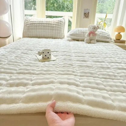 Cream-colored plush quilted bedspread with soft textured surface and fluffy edge cozy faux rabbit fur decorbites