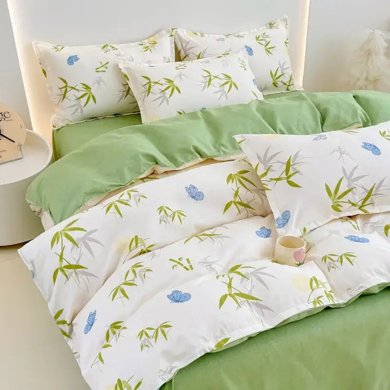 White duvet cover and pillowcases with green bamboo leaves and blue butterflies paired with light green bedsheet decorbites cozy flower print bedding set