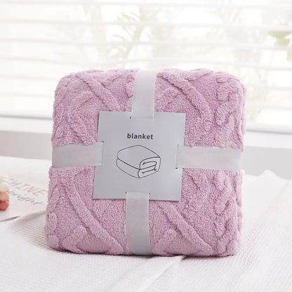A soft plush blanket in lavender with a textured knit pattern wrapped with gray ribbons decorbites cozy jacquard plush