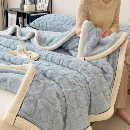 A cozy jacquard taffeta blue and cream flannel nap blanket with a textured quilted pattern for bedroom comfort
