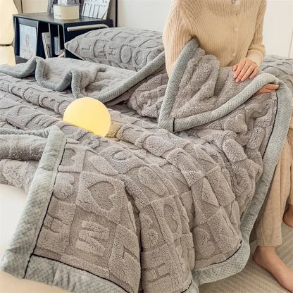 A cozy jacquard taffeta gray plush throw blanket with textured geometric pattern and soft fleece lining for comfort