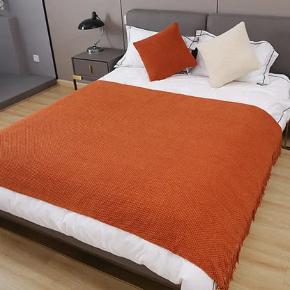 Warm orange textured decorbites cozy knitted sofa blanket with fringed edges for stylish living room decor