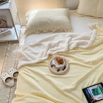 Cream-colored cozy lamb wool blanket with plush fleece texture and subtle ruffled edges for bedroom decorbites cozy lamb