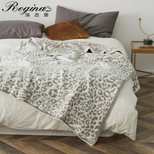 A cozy leopard print knitted bedroom throw blanket in cream with gray leopard print and textured edges by decorbites cozy leopard
