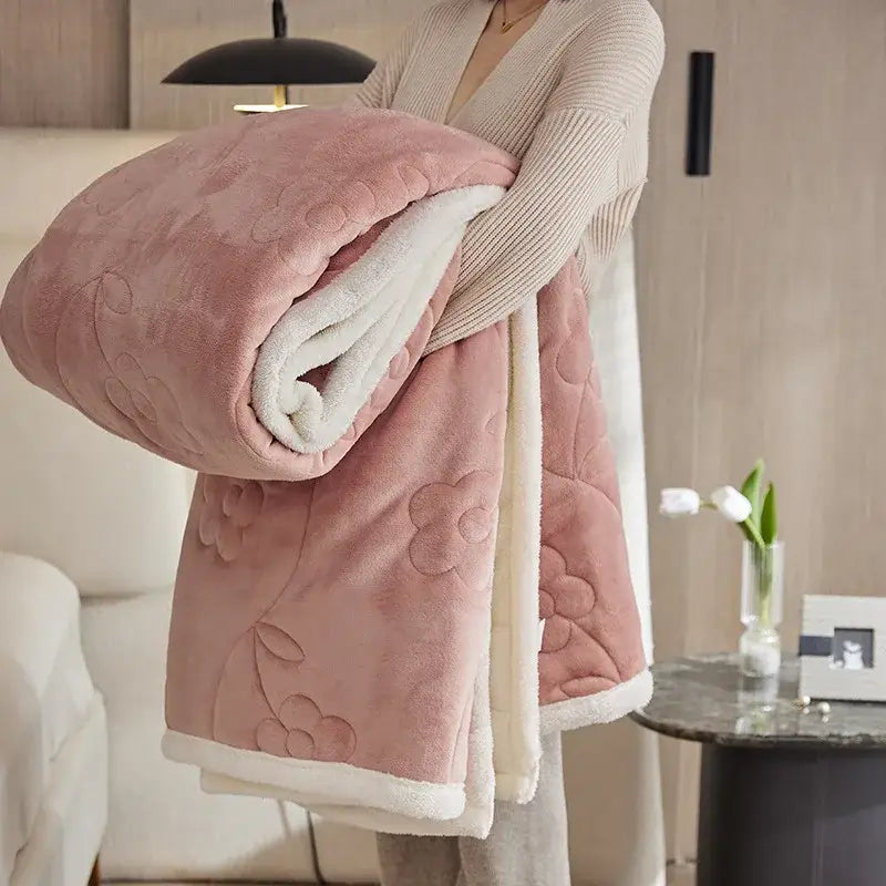 A plush pink and white quilted wool sofa blanket with floral embroidery from decorbites cozy lamb wool sofa collection