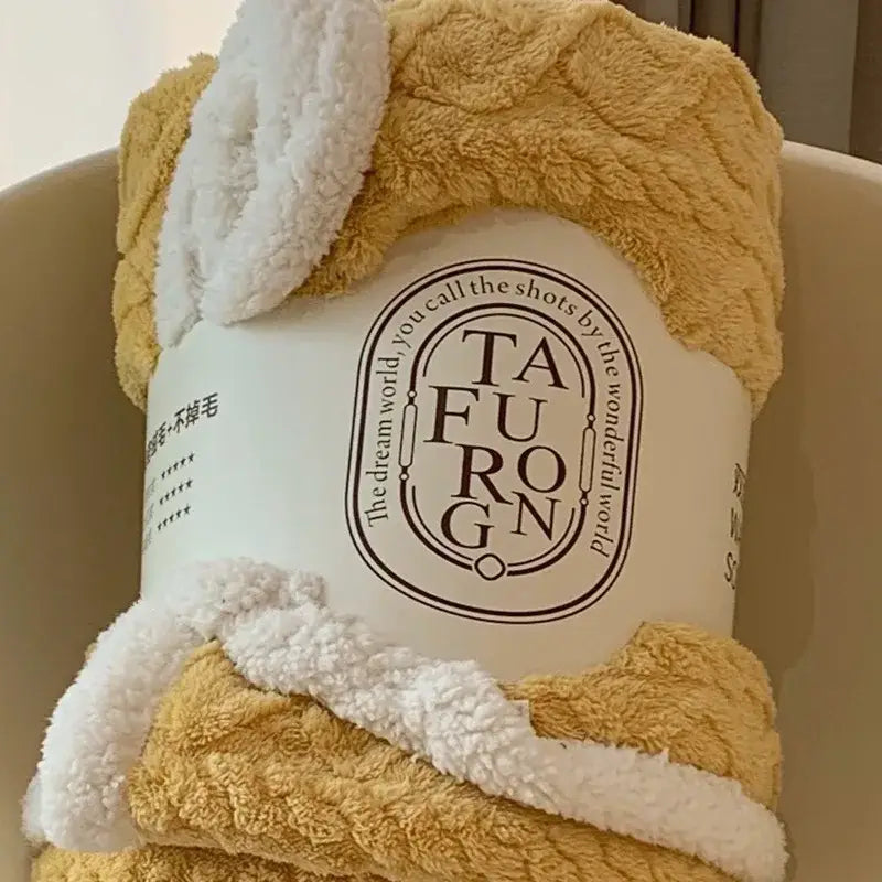 Cozy mustard and white bunny-themed coral fleece blanket made of soft textured sherpa fleece for bedroom use