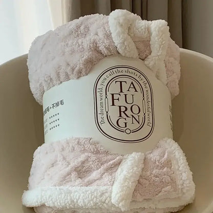 A soft plush pink and white coral fleece blanket with a cozy textured surface perfect as a sherpa throw