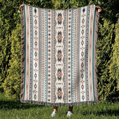 A cozy nordic camping woven throw blanket in cream teal and beige with fringe featuring a geometric pattern for living room decor