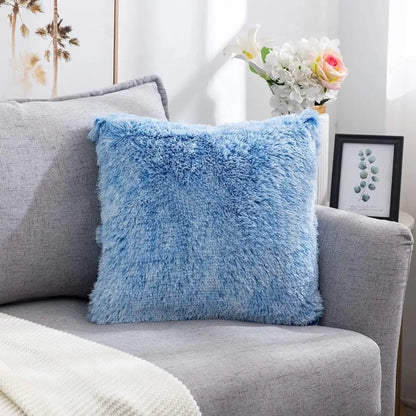 A cozy plush fur light blue cushion cover with soft shaggy texture on a gray sofa for decorbites cozy plush decor