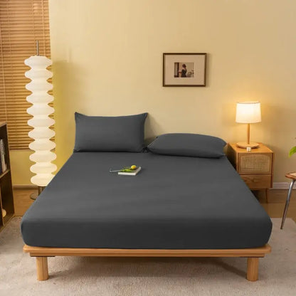 Dark gray fitted sheet with smooth stretchy fabric covering wooden bed frame from decorbites cozy solid color collection