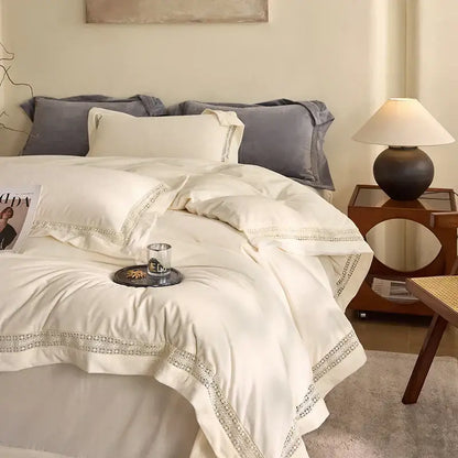 Cream-colored satin bedding set with delicate lace trim from decorbites cozy velvet lace bedroom decor collection