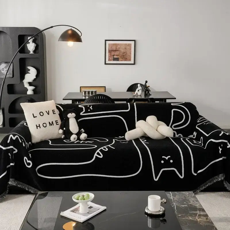 Black chenille sofa cover with white abstract line art and cream and black cat print for living room use