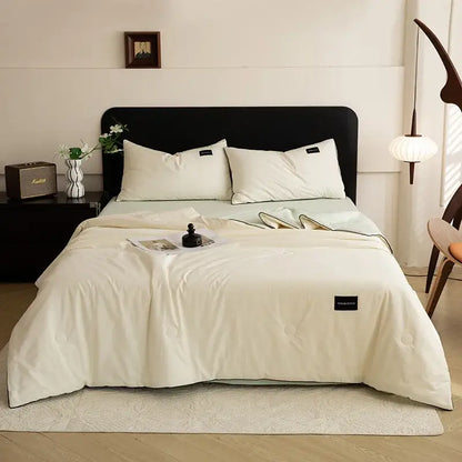 Cream-colored quilted duvet set with subtle black trim and soft cotton texture for ice cream cool summer decorbites cream cool feel