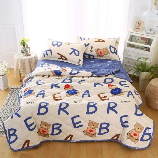Cream bear quilt and pillowcase set featuring cream color, blue and brown lettering, cartoon bears, and stitched pattern for a restful night’s sleep