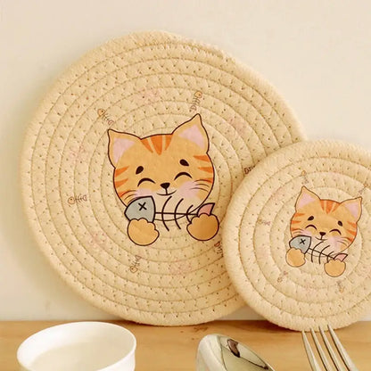 Cream braided rope round coaster in cream with cat print featuring an orange tabby holding fish bones decorbites cat print