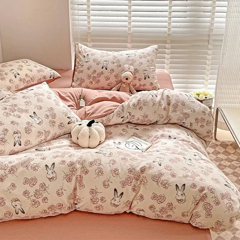 Pastel pink and cream cotton bedding set with decorbites cartoon pattern featuring bunnies and roses