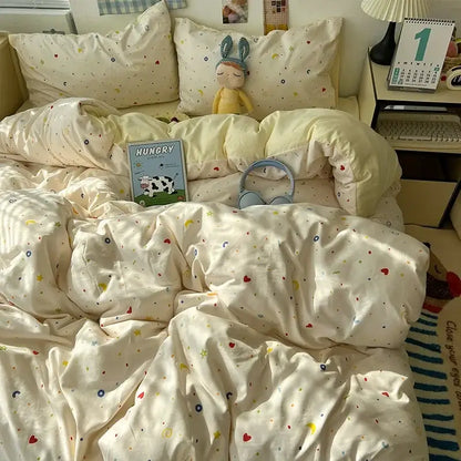 Cream-colored quilted duvet cover with decorbites cartoon pattern printed bedding set featuring hearts moons and stars