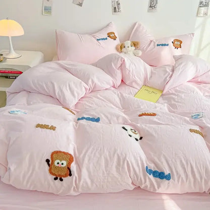 Pink quilted comforter set featuring cartoon embroidery jacquard with toast characters and blue squiggly accents for bedroom use