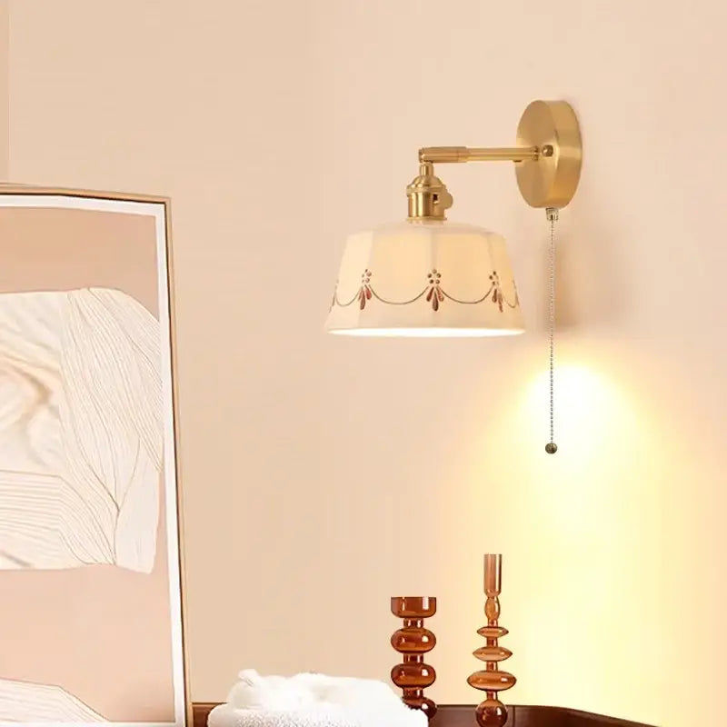Gold-toned decorbites ceramic led wall lamp with cream fabric shade and brown embroidered motifs for bedroom decor