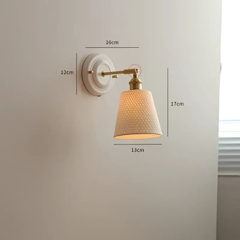 Cream ceramic led wall light with copper arm featuring white textured ceramic sconce and brass-finished lampshade decorbites ceramic led