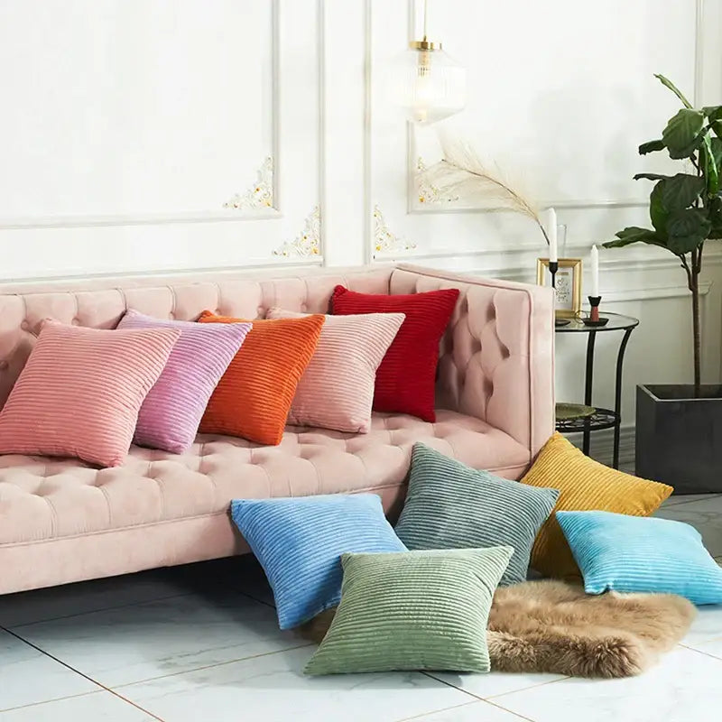 A collection of cream corduroy striped cushion covers in pastel and vibrant hues on a tufted pink sofa decorbites corduroy striped cushion decor