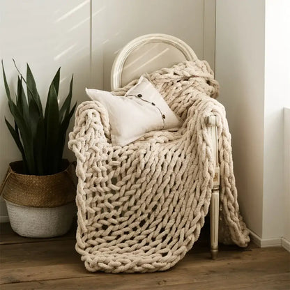 Cream cozy chenille chunky knit blanket draped over a chair showcasing ultra-thick chenille chunky knit decorbites throw