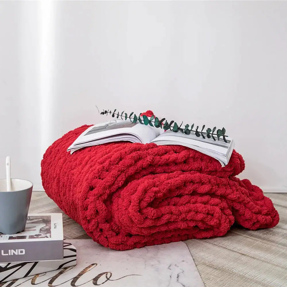 A vibrant red plush decorbites cozy chenille chunky knit throw blanket with a textured surface for bedroom decor