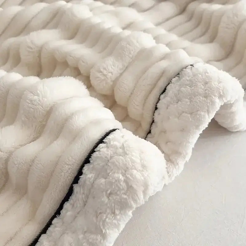 Cream cozy decorbites plush blanket with ribbed texture black piping edge made of cozy faux rabbit fur