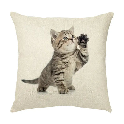 Beige linen throw pillow with a cute cat face decorative print of a tabby kitten raising a paw for living room use