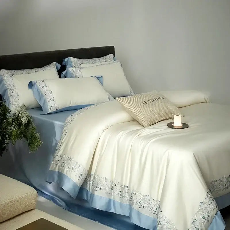 Cream embroidered egyptian cotton bedding set with satin duvet cover featuring light blue trim and silver floral embroidery