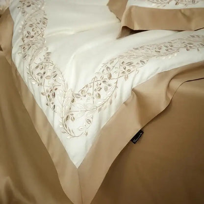 Cream embroidered egyptian cotton bedding set with cream satin bedspread and silver thread leafy vine embroidery along edge