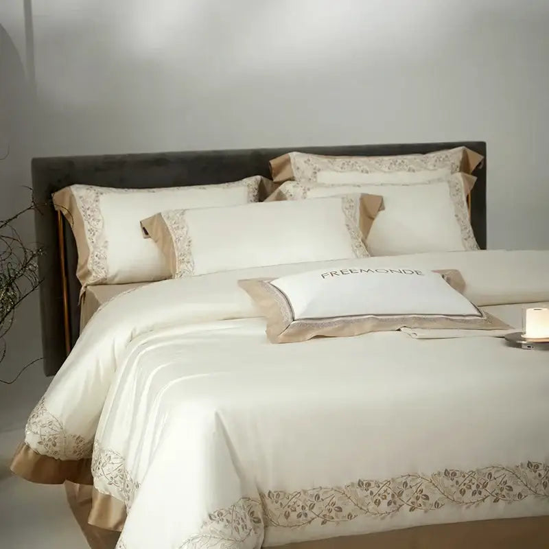 Cream embroidered egyptian cotton bedding set featuring a cream satin duvet cover with beige floral embroidery and matching pillowcases