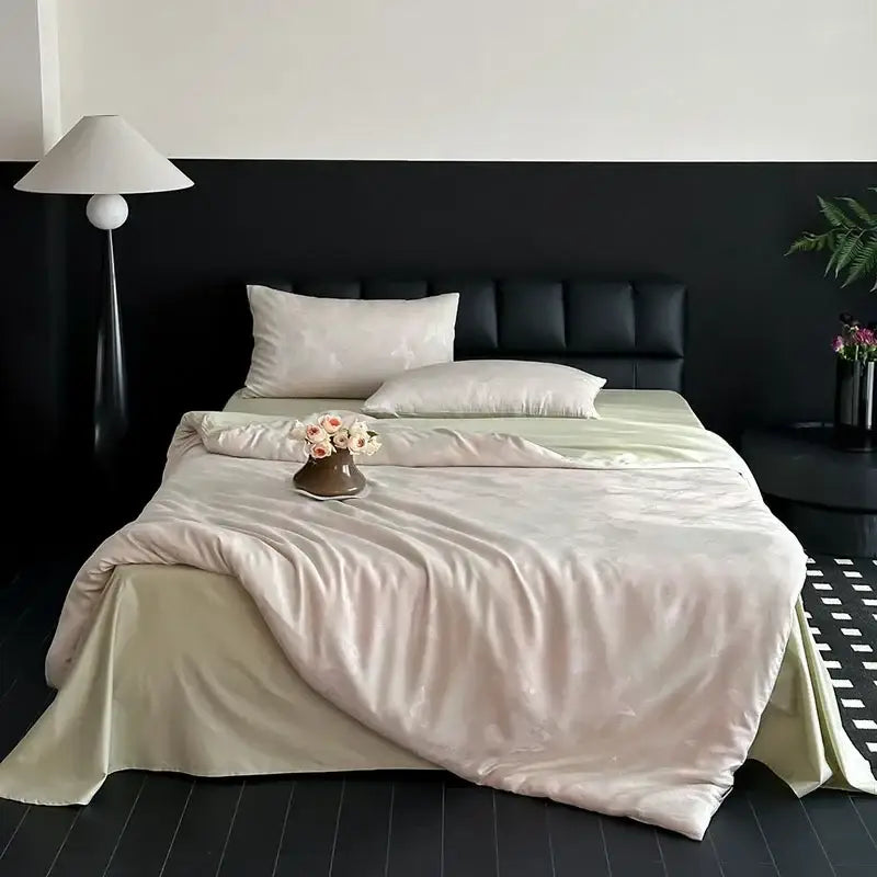 Cream floral cotton jacquard bedding set with cream satin duvet cover and pillowcases on black tufted bed