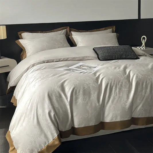 Cream floral jacquard bedding set featuring cream satin duvet cover with subtle floral embroidery and gold-toned trim