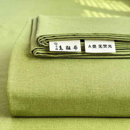 Neatly folded olive-green cotton fabric with textured weave and stitching for decorbites cooling cotton bed cover protector