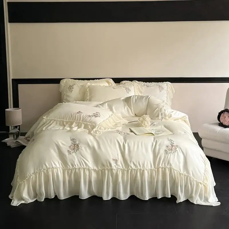 Cream-colored satin lyocell bedding set with decorbites flowers embroidery and delicate lace ruffles for bedroom use