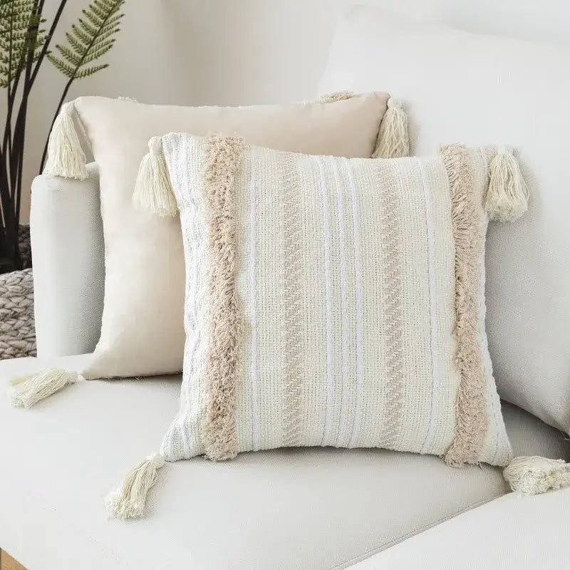 Beige woven cushion cover with vertical striped pattern fringed tassels and decorbites geometric embroidery detail
