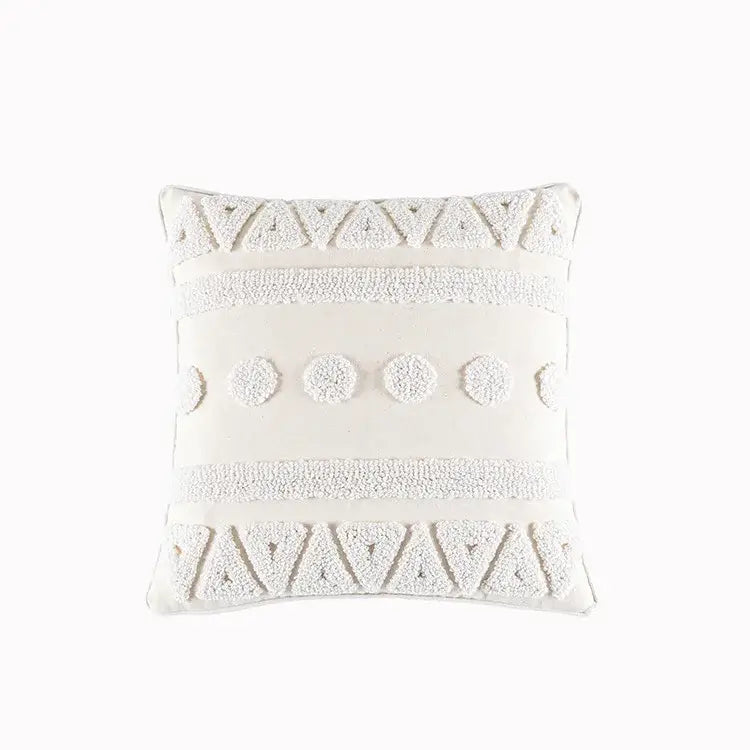 Off-white square cushion cover with cream geometric embroidery and textured tassels featuring tufted patterns