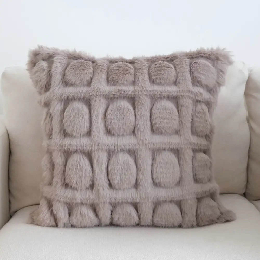 A plush taupe cream geometric faux fur throw pillow with textured fuzzy surface and embossed rounded circles decorbites cream geometric