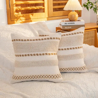 Cream geometric tufted cushion cover with cream-colored textured throw pillows and beige embroidered details for living room decorbites