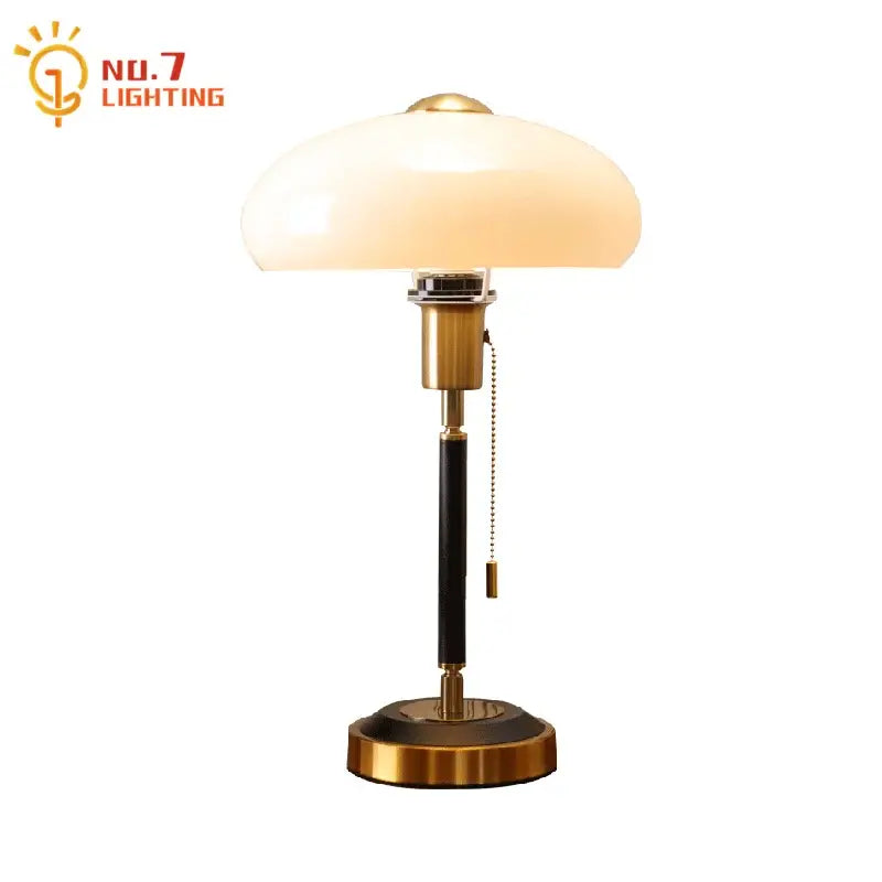 Brass-finished table lamp with cream glass mushroom shade and black textured column for decorbites cream glass decor
