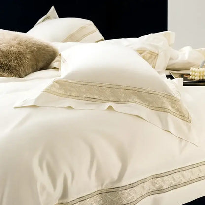 Cream-colored satin pillowcases with gold-threaded wide edge embroidery from decorbites bedding set available in two sizes