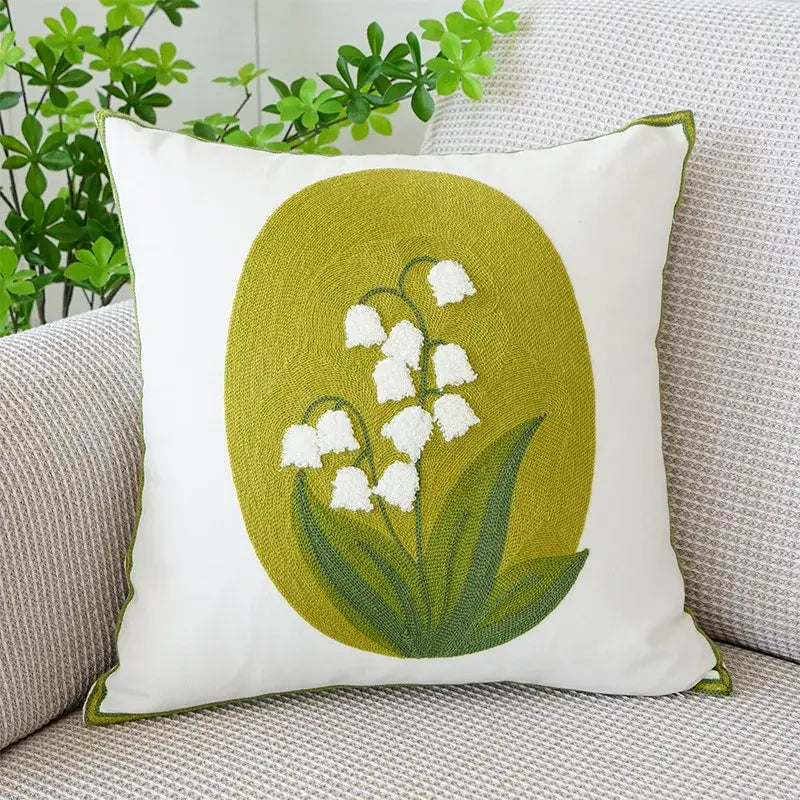 Cream green tulip embroidery cushion cover with white lily of the valley on olive green oval and decorbites green piping