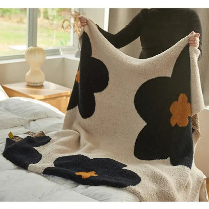 Cream korean kawaii flower plush throw blanket in cream with black and orange floral patterns for cozy decorbites decor